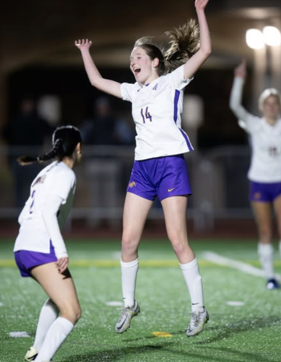 Senior Lilly Lucas celebrates with her teammates during the Winter Whiteout Match